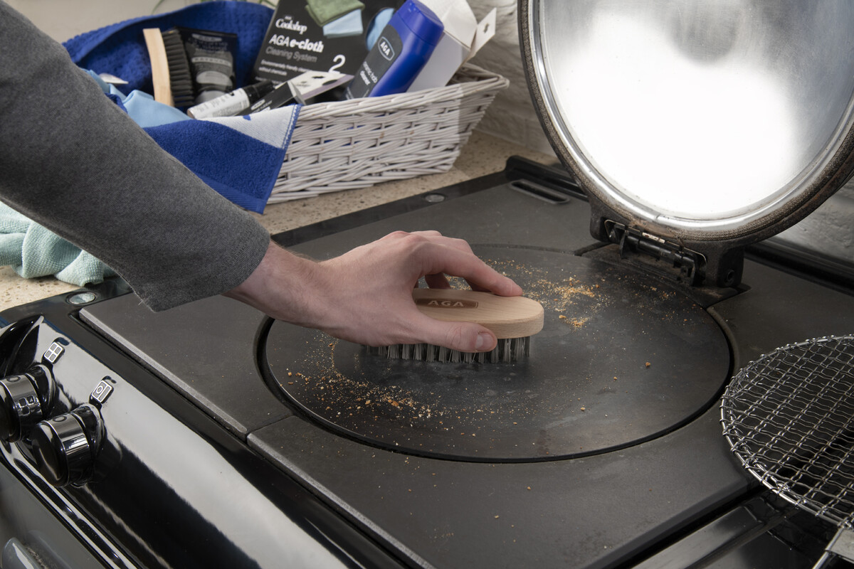 AGA cast-iron hotplate cleaning with wire brush