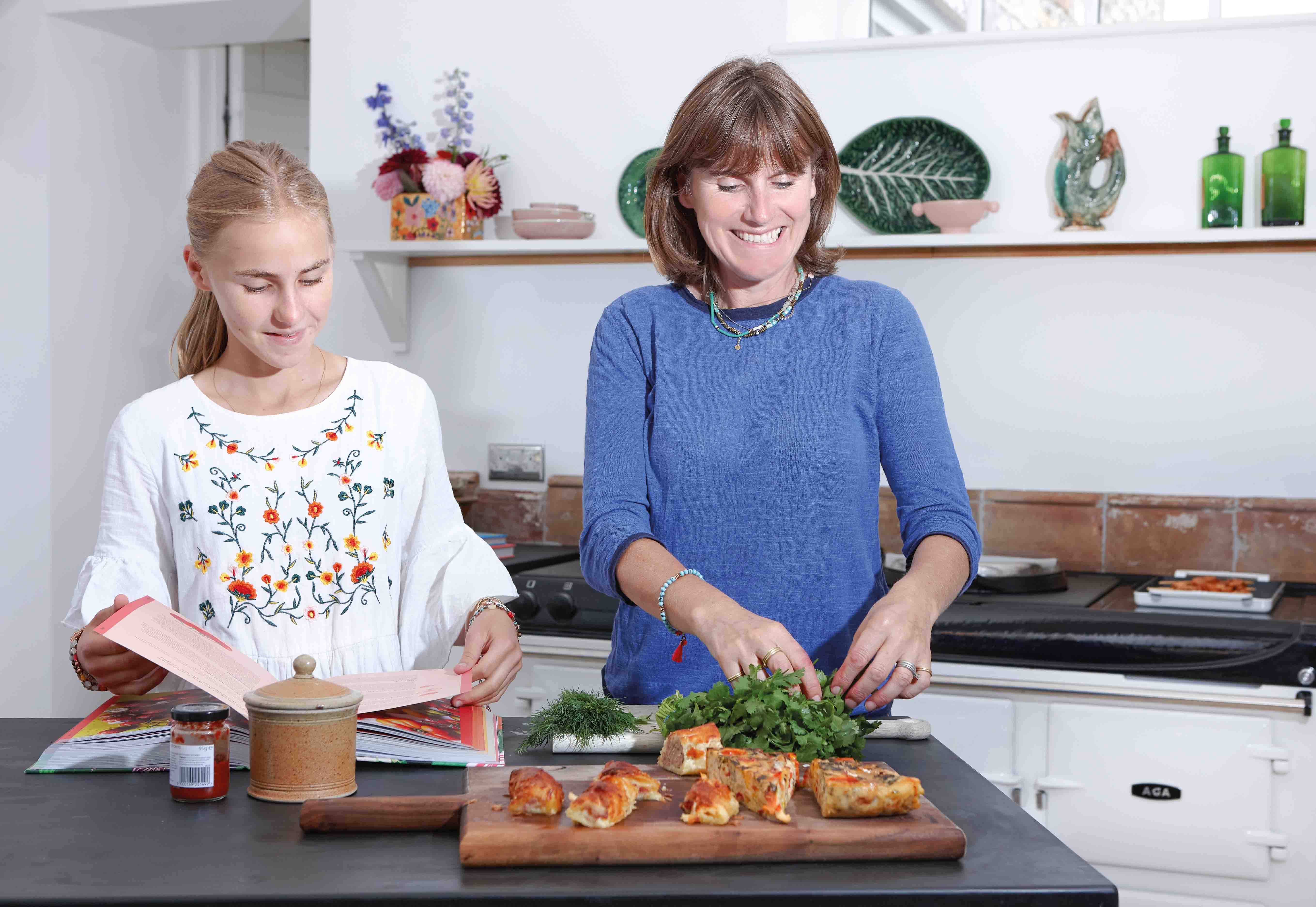 Sarah Moore and her daughter cooking in front of the AGA