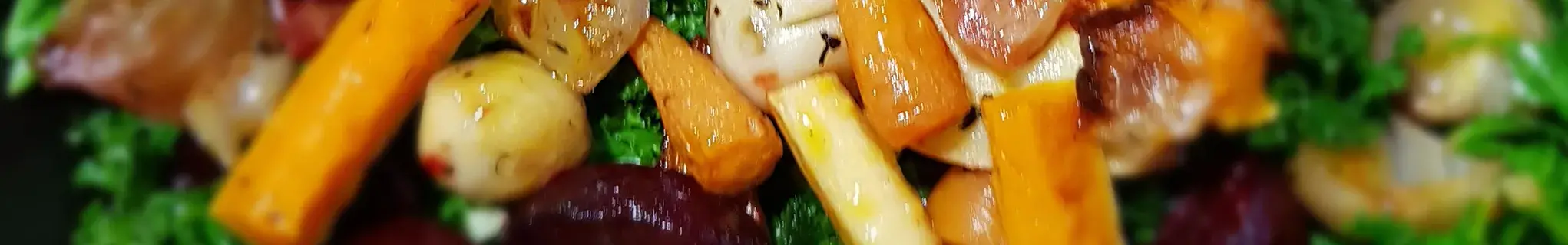 Colourful vegetables on a bed of steamed kale
