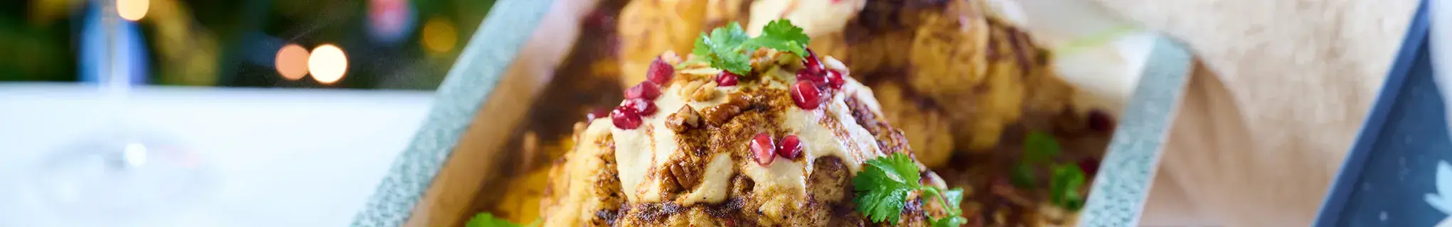 Whole Roasted Harissa Cauliflower with Hummus Dressing