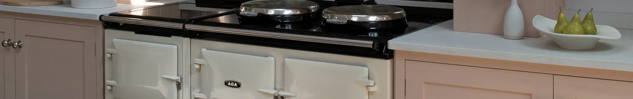 AGA 7 Series in White surrounded by pink shaker style cabinetry 