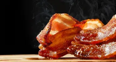 Hot streaky bacon with steam rising 