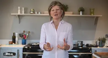 AGA Demonstrator Na Hansell in front of black AGA