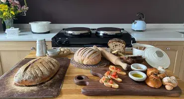 Sourdough Loaf Baked and served on wood board in front of Blush AGA 