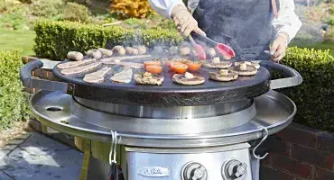 AGA Outdoors grill with breakfast food cooking on circular cooktop
