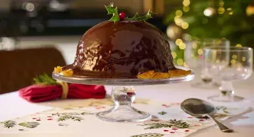Chocolate Orange Pudding with Chocolate Orange Sauce and a holly decoration
