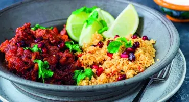 Moroccan Lamb Tagine served in bowl with rice, coriander and lime