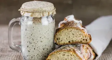 Sourdough Starter in jar and sourdough bread