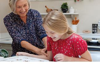 Grandmother and child baking