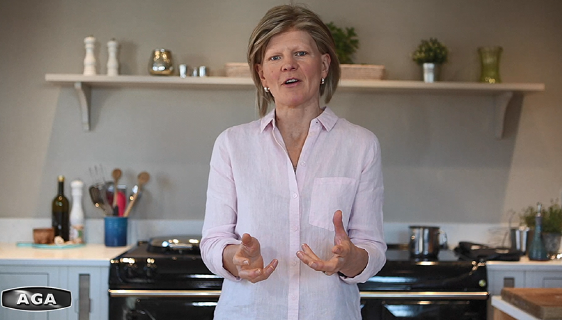 AGA Demonstrator Na Hansell in front of black AGA