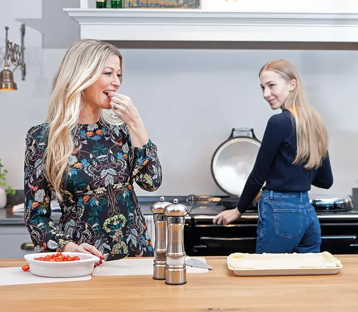 Mother and daughter cooking and eating by the AGA 