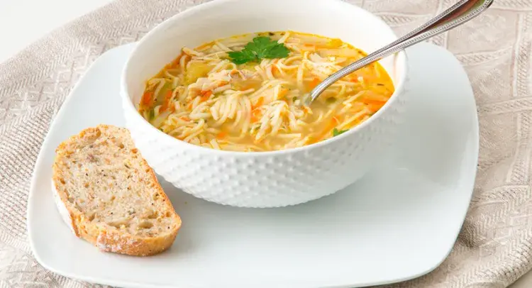 Chicken Noodle Soup in bowl with bread